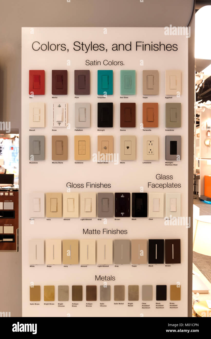Display showing various colors, styles, and finishes for wall light switches and faceplates in a lighting store. Stock Photo