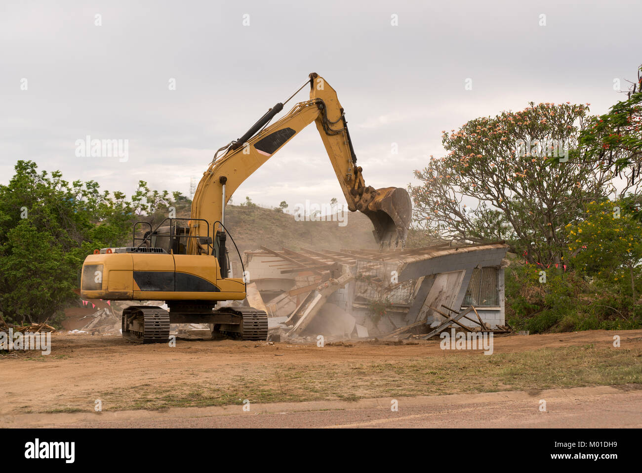 Bulldozer knocking down old house to rebuild Stock Photo Alamy