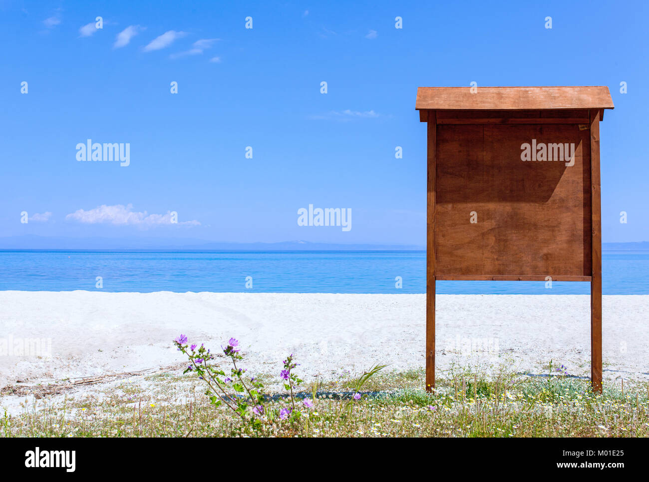 sign board on an empty beach near the ocean Stock Photo