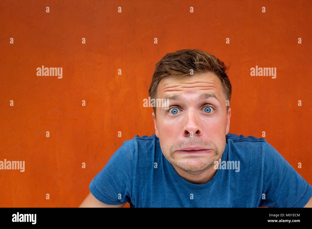 Caucasian man with funny face on red background Stock Photo