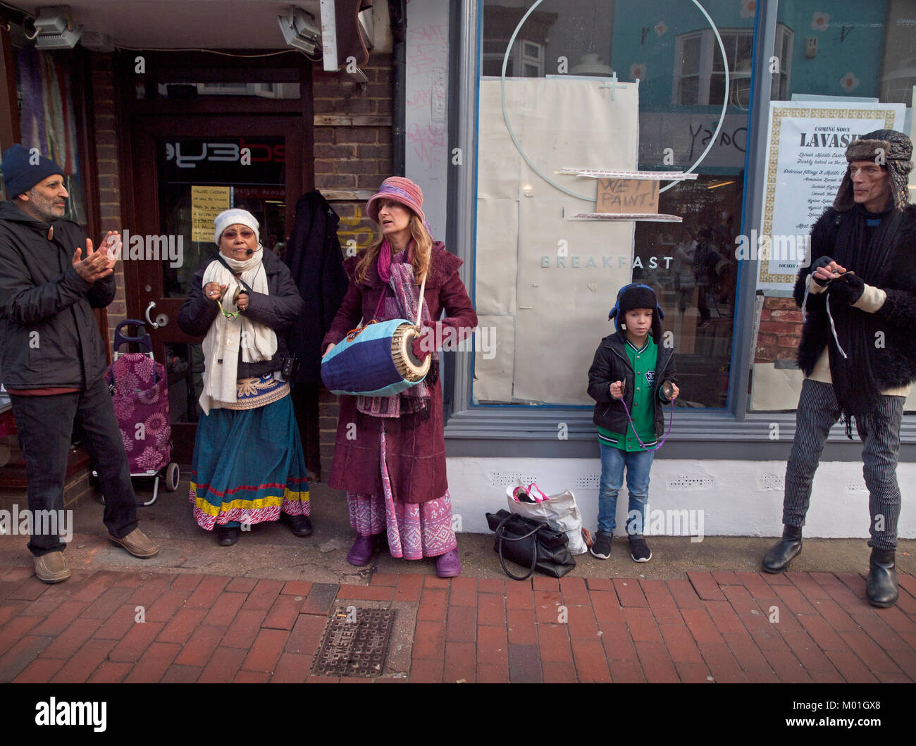 Members of the Hare Krishna movement chant and make music on a Brighton street Stock Photo