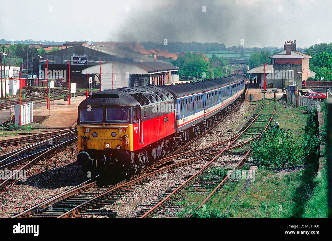 A class 47 diesel locomotive number 47712 powers away from the Andover stop with a Network Southeast 'Network Express' service. Andover. 4th May 1992. Stock Photo