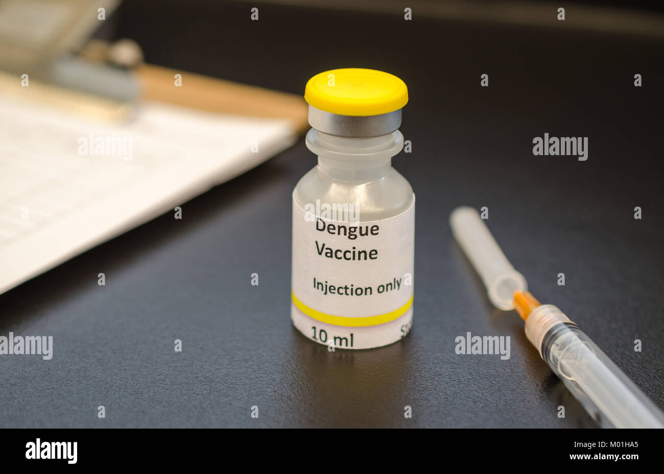 Dengue virus vaccine vial with syringe Stock Photo