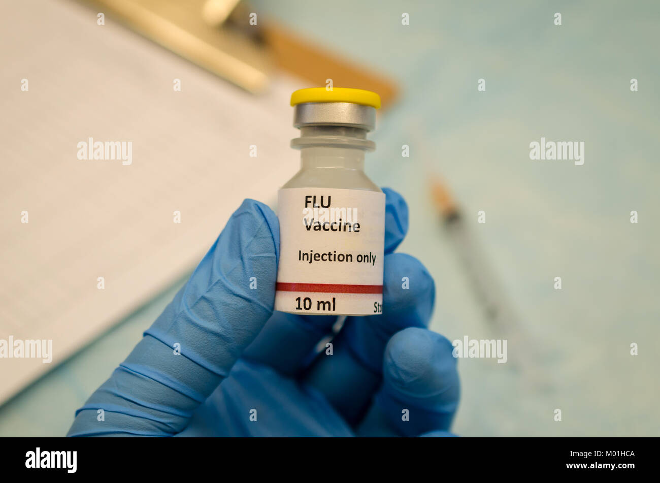 Doctor showing Flu vaccine vial in clinic Stock Photo
