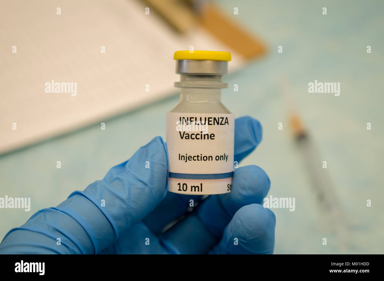 Influenza virus vaccine holding in hand Stock Photo