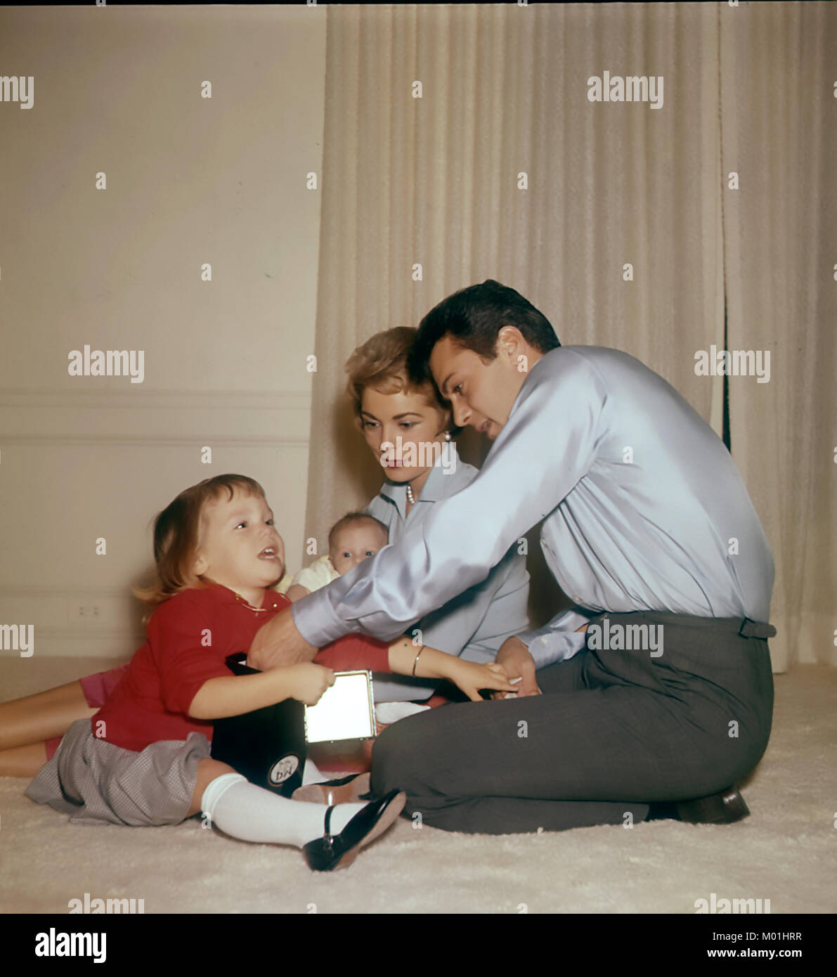 JANET LEIGH and husband Tony Curtis about 1957 with daughters Jamie at left and baby Kelly Stock Photo