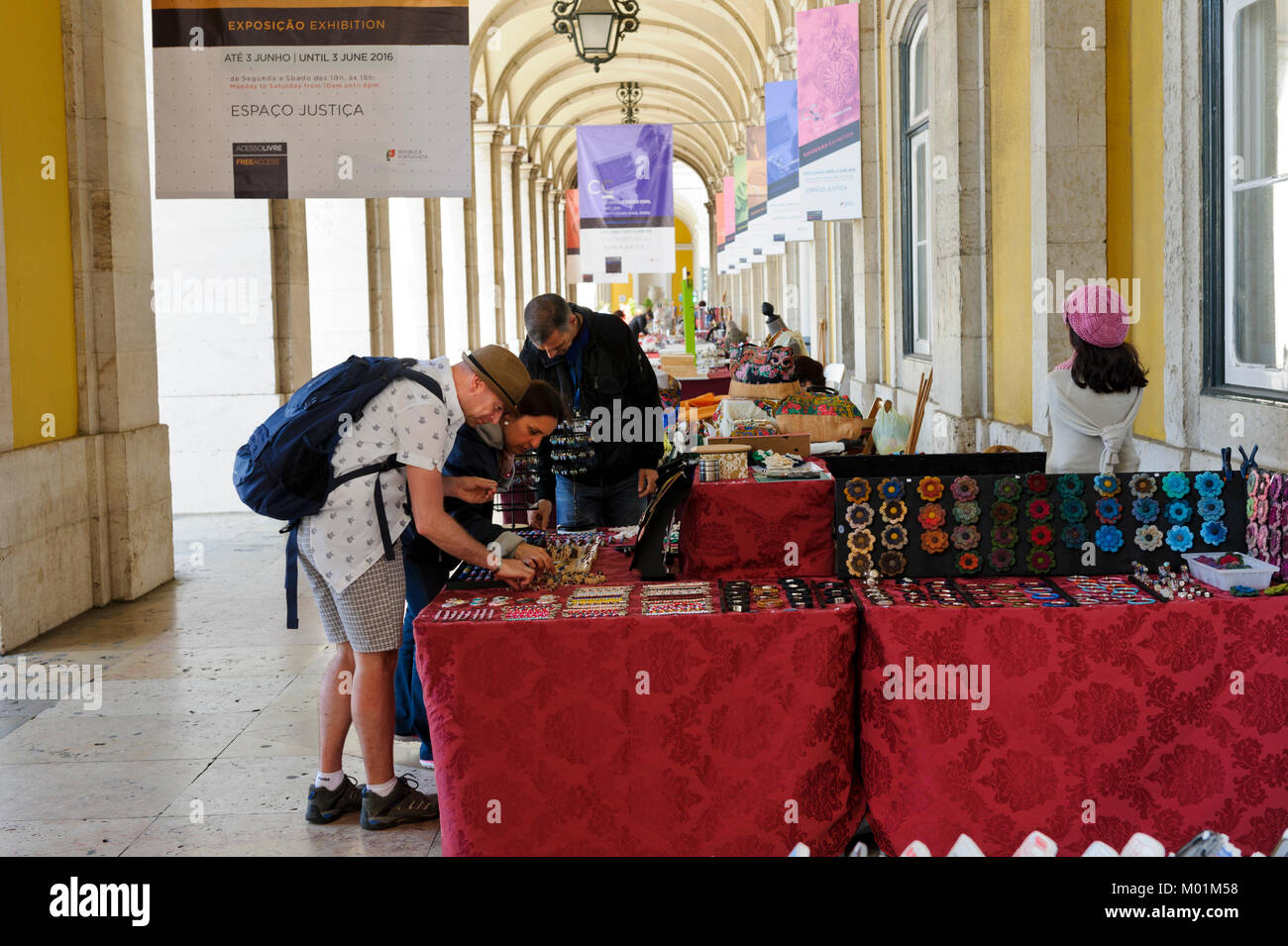 Visitors examining craft pieces on sale by small traders, Lisbon, Portugal Stock Photo