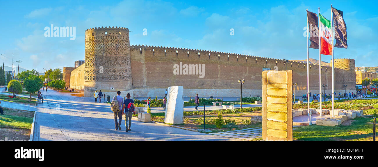 SHIRAZ, IRAN - OCTOBER 12, 2017: Karim Khan Arg (citadel), located in Shohada square, is surrounded by nice park with green lawn and flower beds, on O Stock Photo