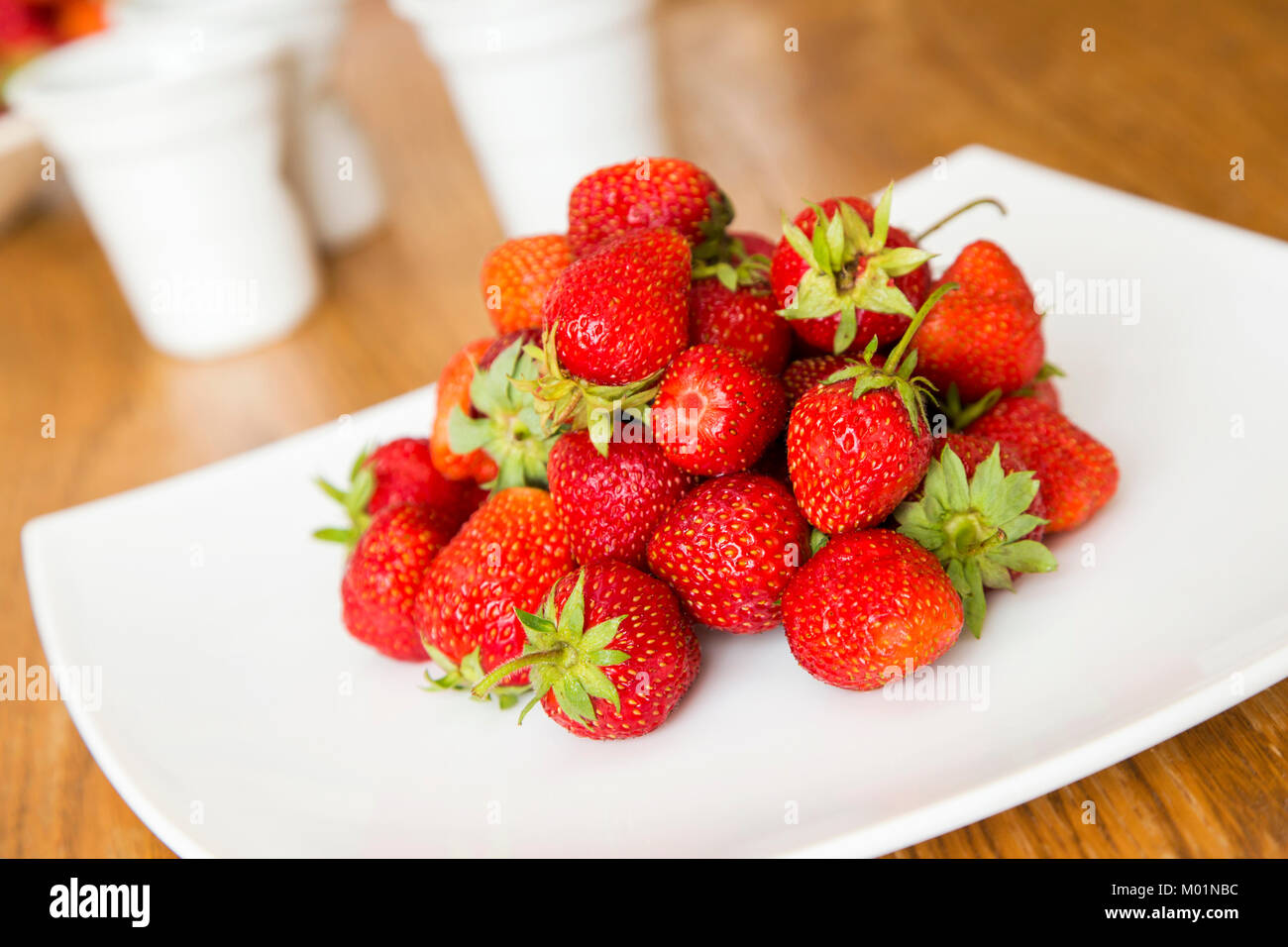 Fresh strawberries on a white dish Stock Photo - Alamy