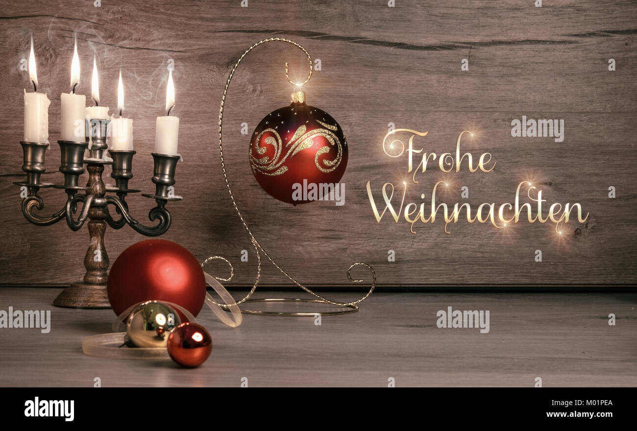 Stil life with Christmas decorations on wood, caption 'Frohe Weihnachten' on toned image Stock Photo