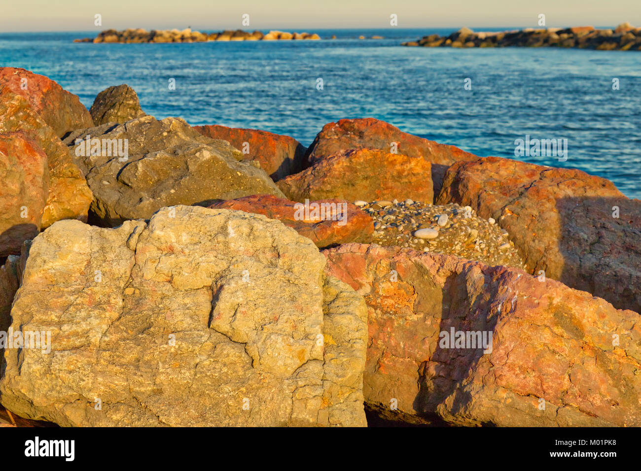 Italian Beaches Rocks rocks along pier on Adriatic coast in Italy Stock Photo - Alamy