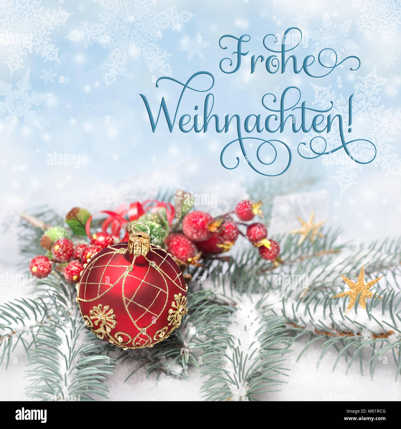 Red Christmas decorations on neutral winter background, greeting 'Frohe Weihnachten', or 'Merry Christmas' in German Stock Photo
