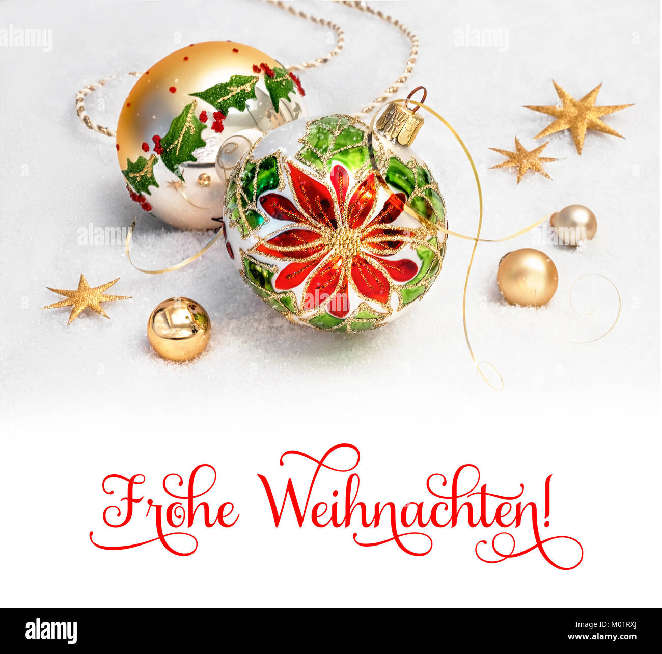 Christmas greeting card. Christmas baubles with poinsettia design and golden decorations on snow. Caption 'Frohe Weihnachten' ('Merry Christmas' in Ge Stock Photo