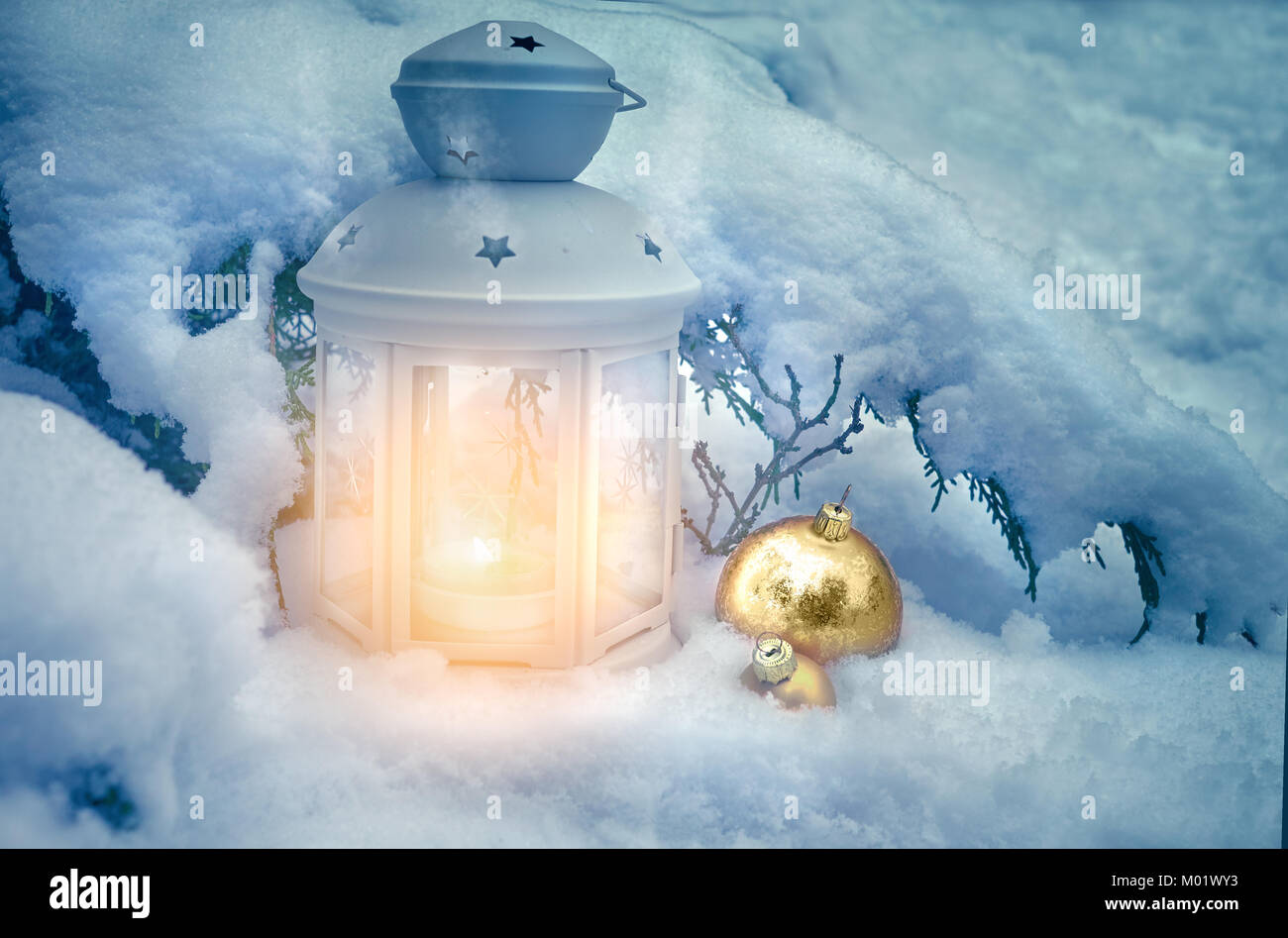 Little winter lanterns outdoors on a Christmas tree under snow. Merry  Christmas! This image is toned Stock Photo - Alamy
