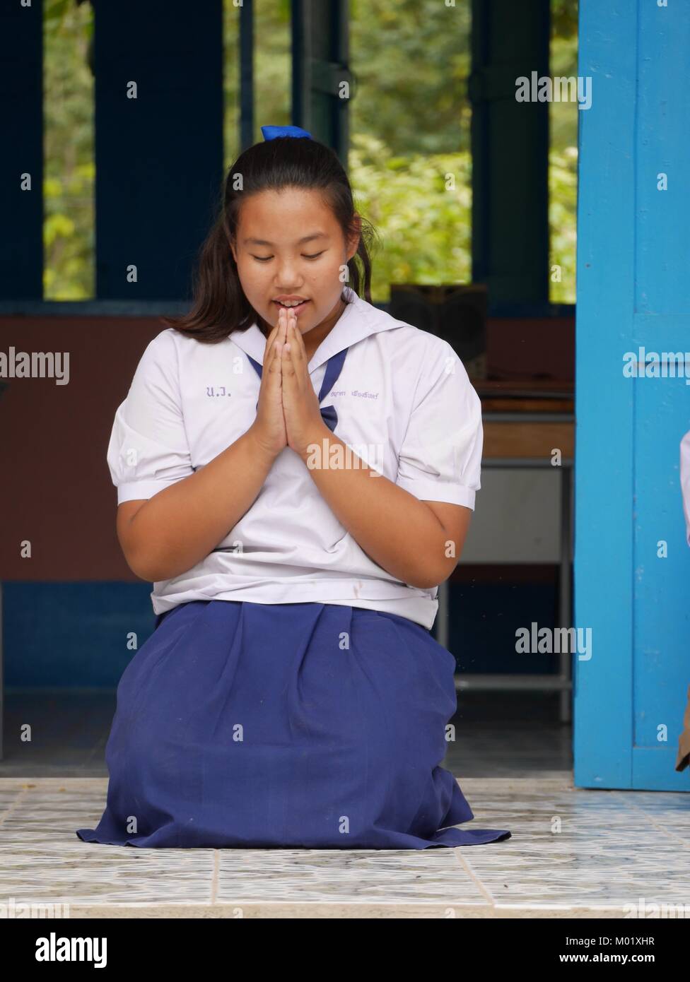 Thai student praying, Northern Thailand Stock Photo