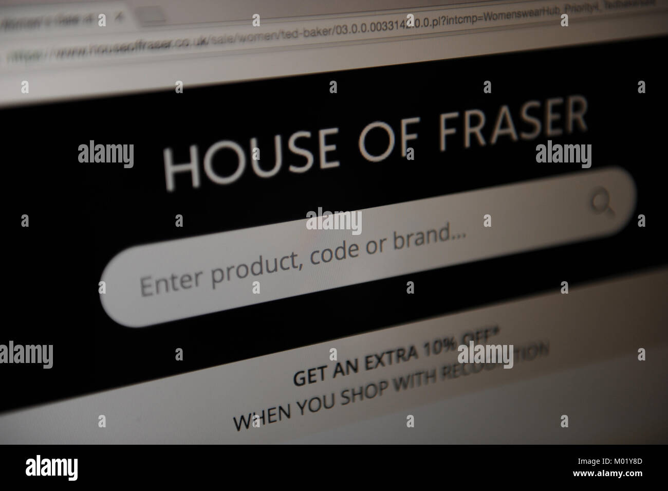 A woman looks at the House of Fraser website Stock Photo