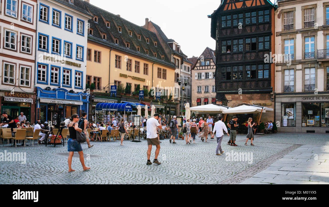 STRASBOURG, FRANCE - JULY 10, 2010: tourists on square Place de La Cathedrale near medieval houses. Roman Catholic cathedral was built in 1015-1439 ye Stock Photo