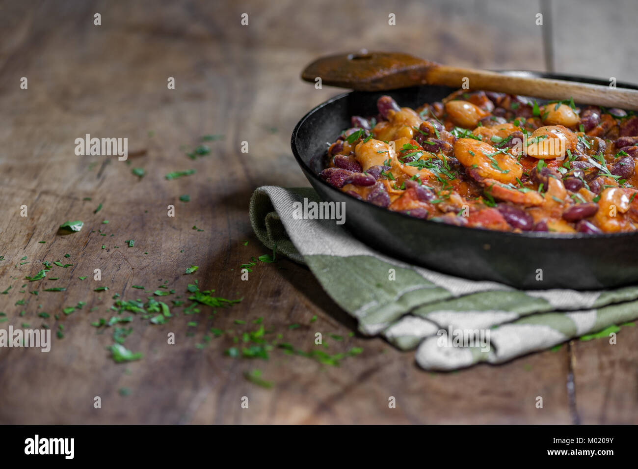 Chilli con carne with herbs in a pan Stock Photo Alamy