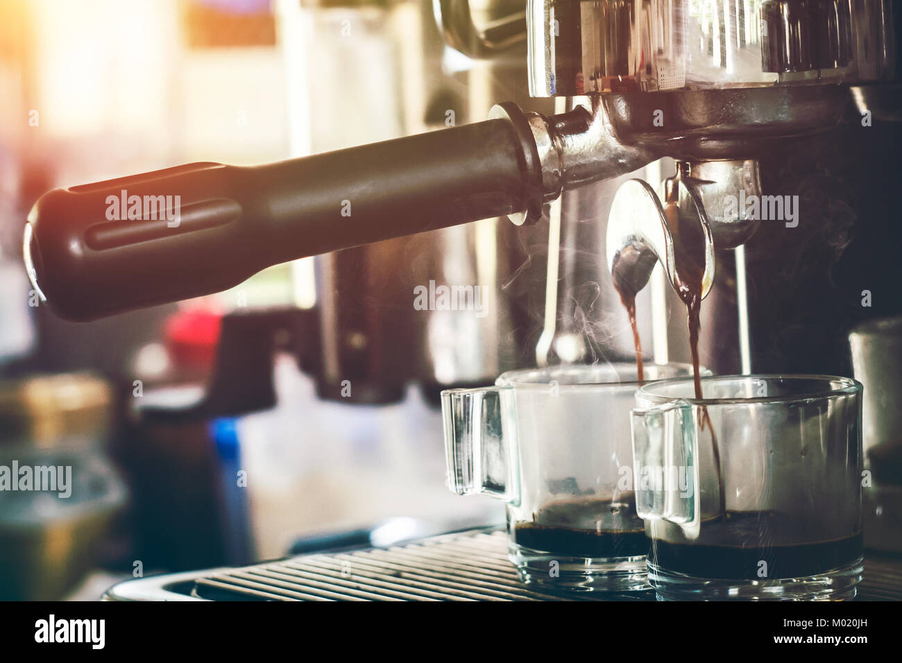 Close-up Of Espresso Machine Pouring Coffee In A Glass Stock Photo