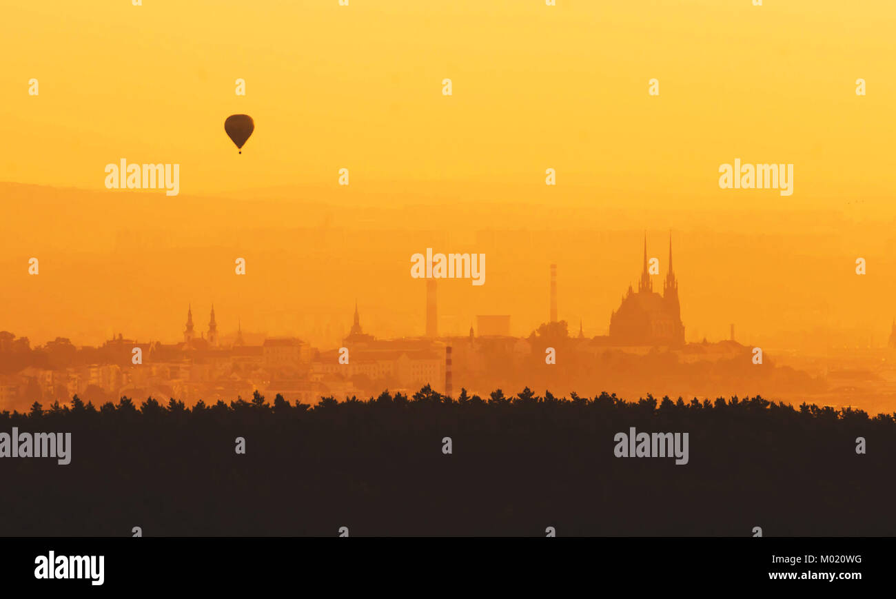 Morning over Brno - Czech Republic, Sunset over the City, Silhouette of Cathedral Petrov and hot air balloon Stock Photo