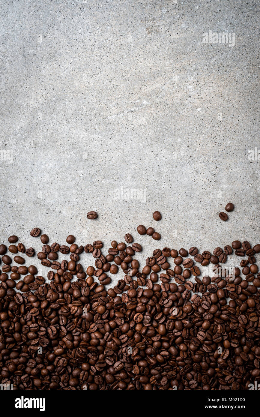 Roasted coffee beans on gray stone background. Close up Stock Photo - Alamy