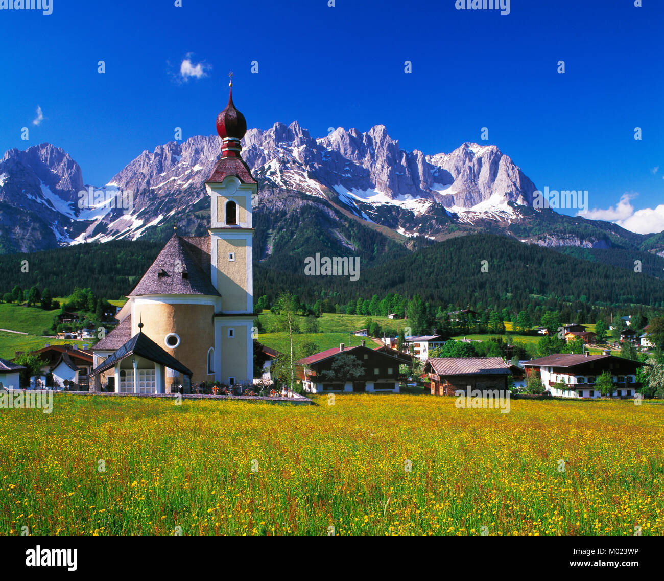 Going church and village and the Kaiser Wilhem mountain range, Tirol, Austria Stock Photo