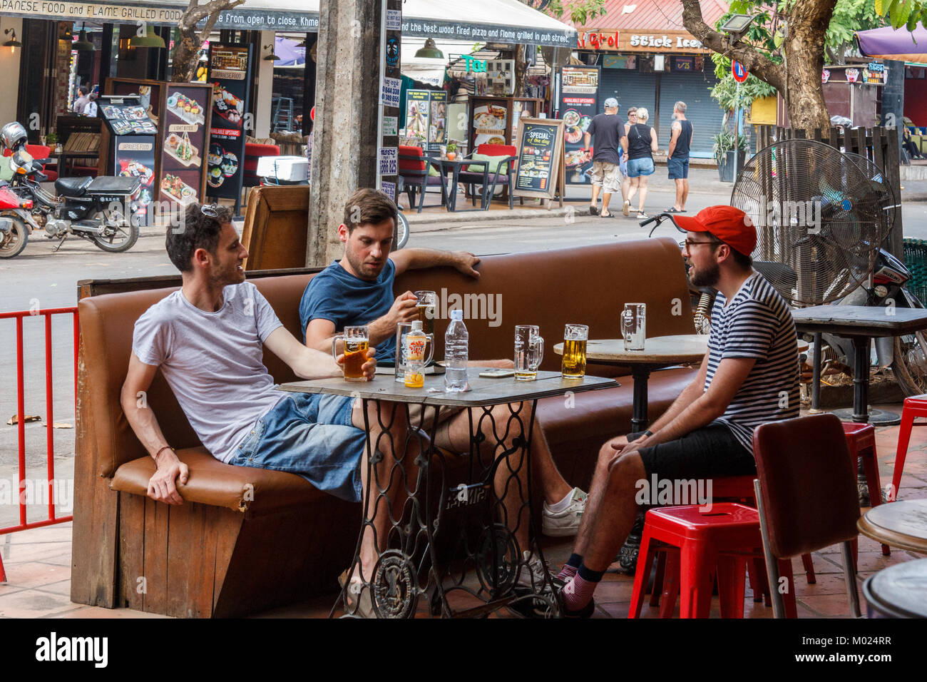Young men drinking in a bar, Pub Street, Siem Reap, Cambodia Stock Photo