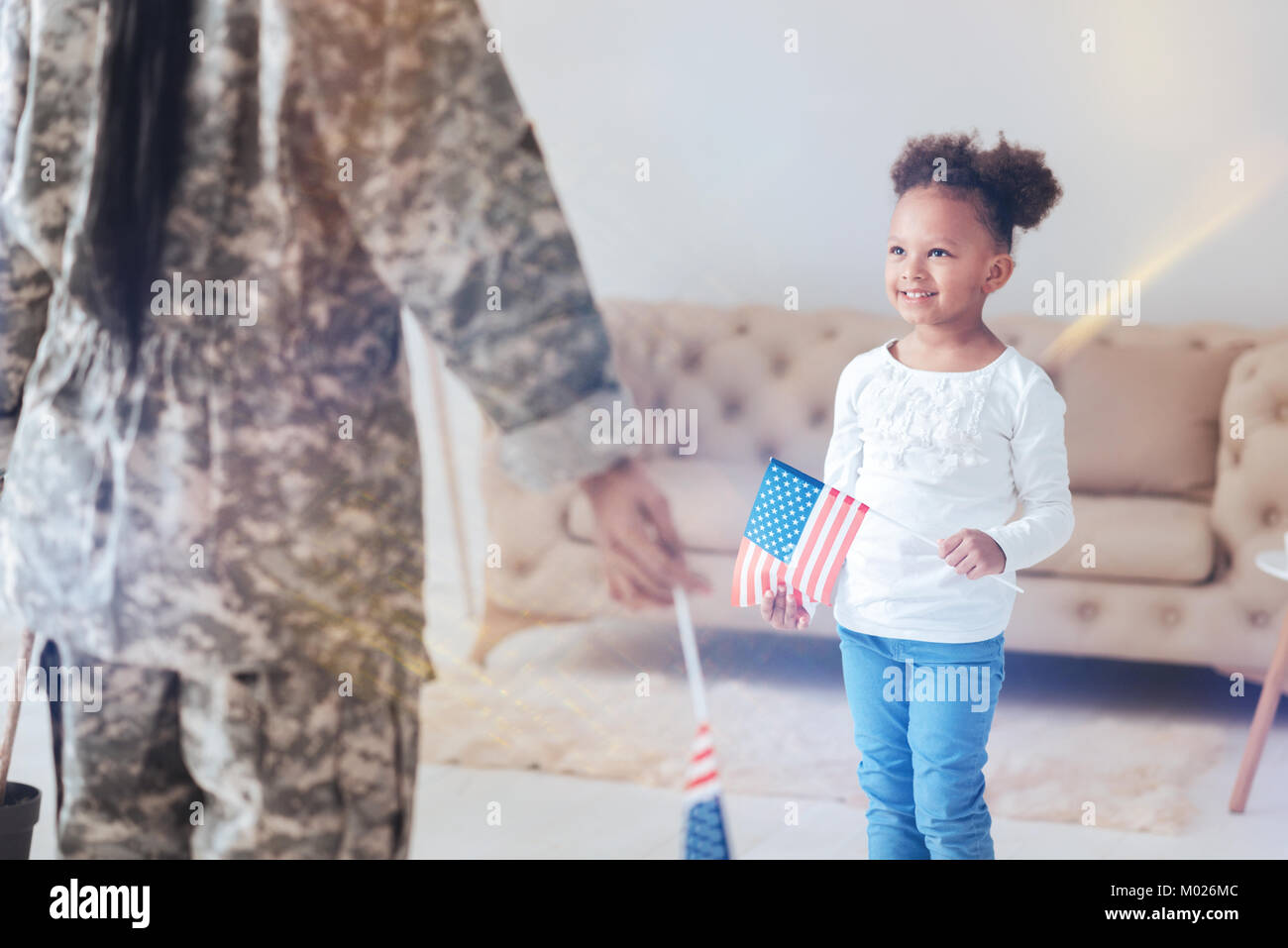 Cheerful pretty girl holding a US flag Stock Photo - Alamy