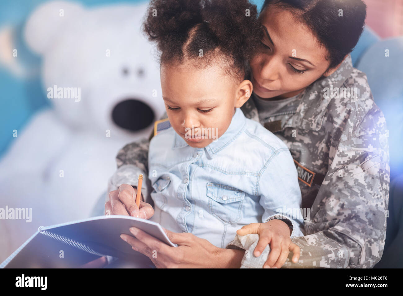 Positive smart woman teaching her daughter Stock Photo