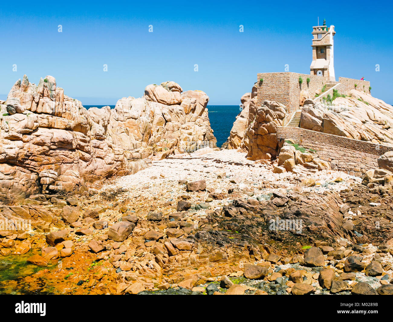 travel to France - Paon Lighthouse (Phare du Paon) on pink granite coast of Ile-de-Brehat island in Cotes-d'Armor department of Brittany in summer sun Stock Photo