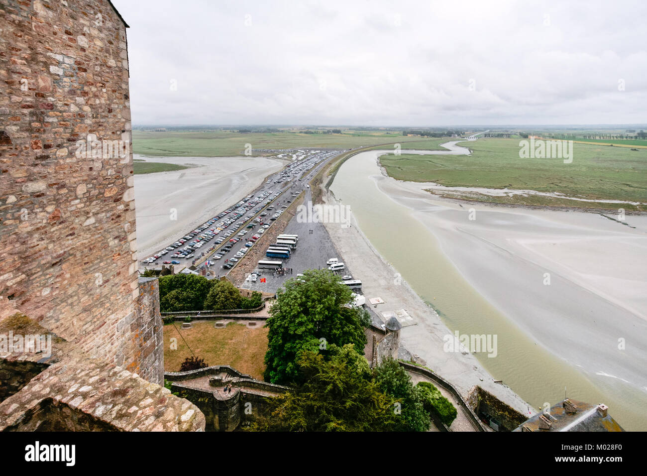 Travel to France - above view of car parking and the causeway to Le Mont Saint-Michel island in Normandy in rain Stock Photo