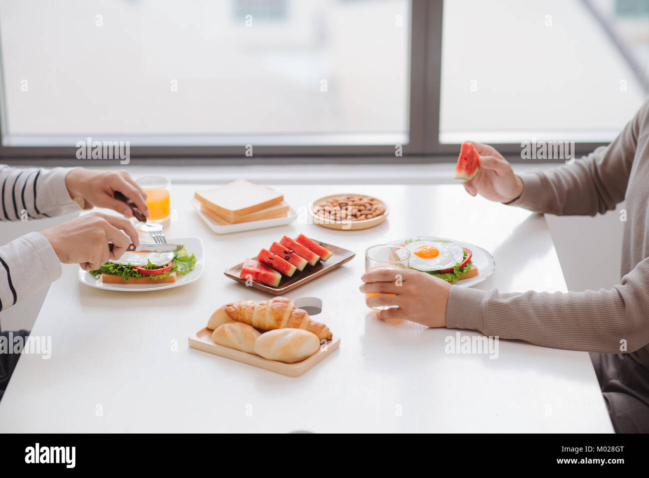 Two male friends eating breakfast at home in morning Stock Photo Alamy