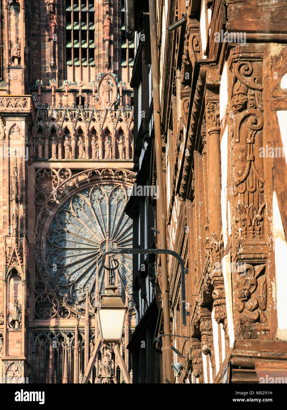 trave to France - urban lantern on street Rue Merciere and west facade of Strasbourg Cathedral in summer evening Stock Photo