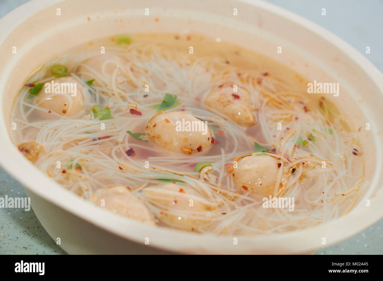 Thai style fish ball noodle soup with chili flakes Stock Photo Alamy