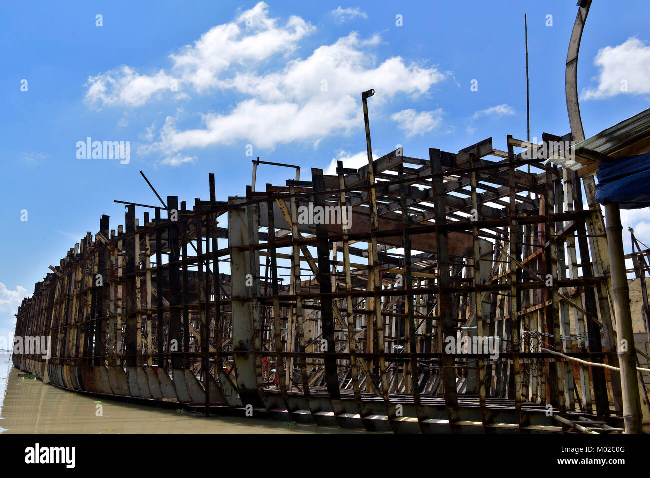 DHAKA, BANGLADESH – AUGUST 19, 2017: Bangladeshi workers build a ship at a shipbuilding yard on the bank of River Padma in Dohar, near Dhaka, Banglade Stock Photo