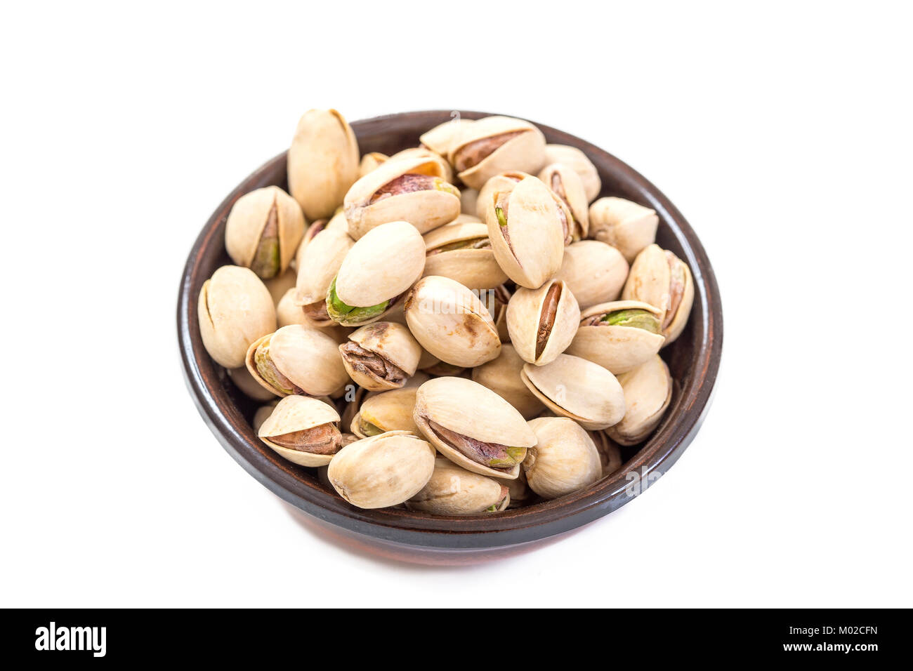 Dry salted pistachio fruit in bowl isolated on white Stock Photo Alamy