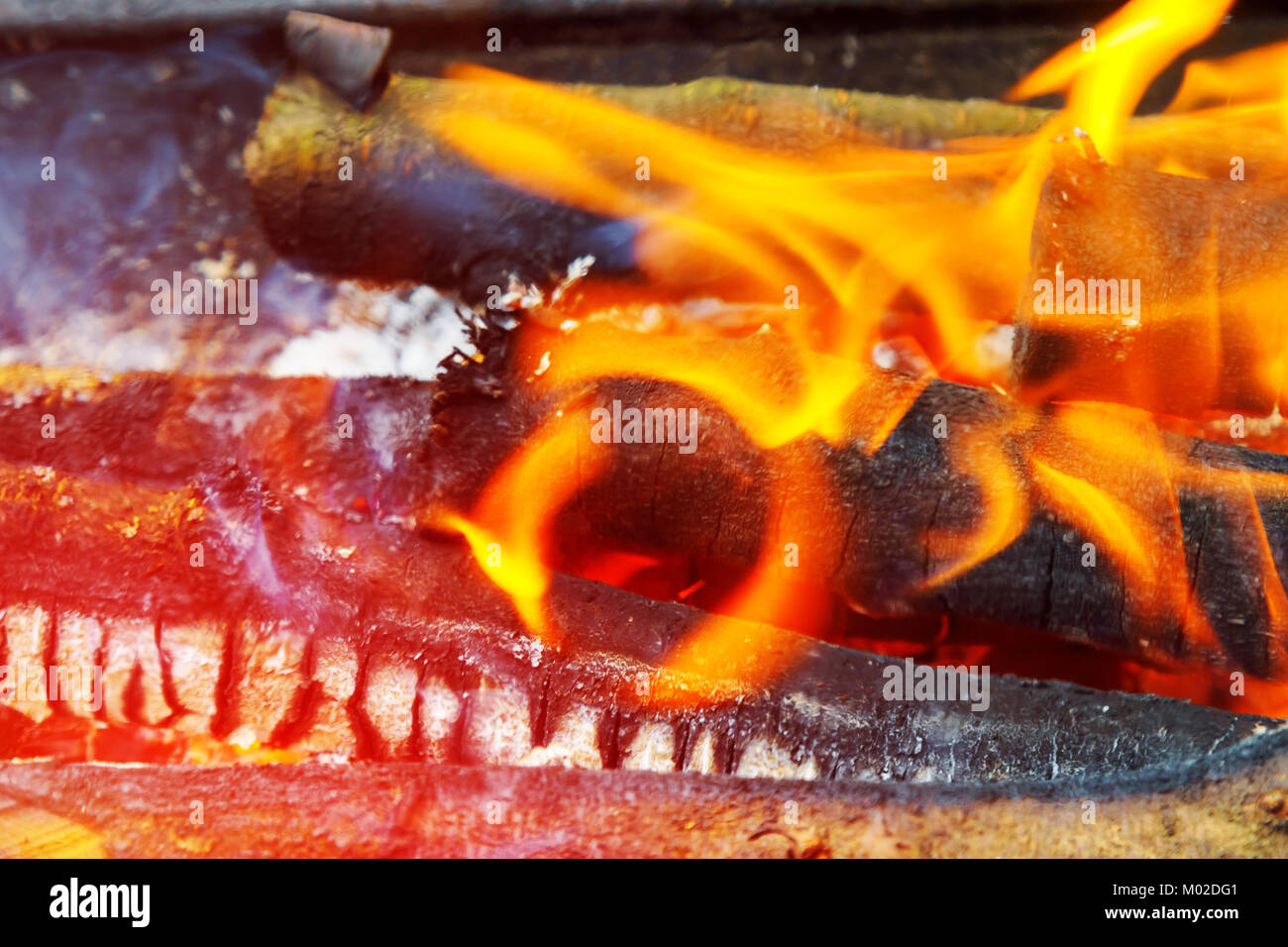 Dance of flames against a dark background, wood burning grill in the