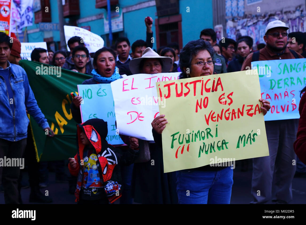 A woman holds a placard demanding justice during a march protesting against pardon granted former president Alberto Fujimori, Cusco, Peru Stock Photo