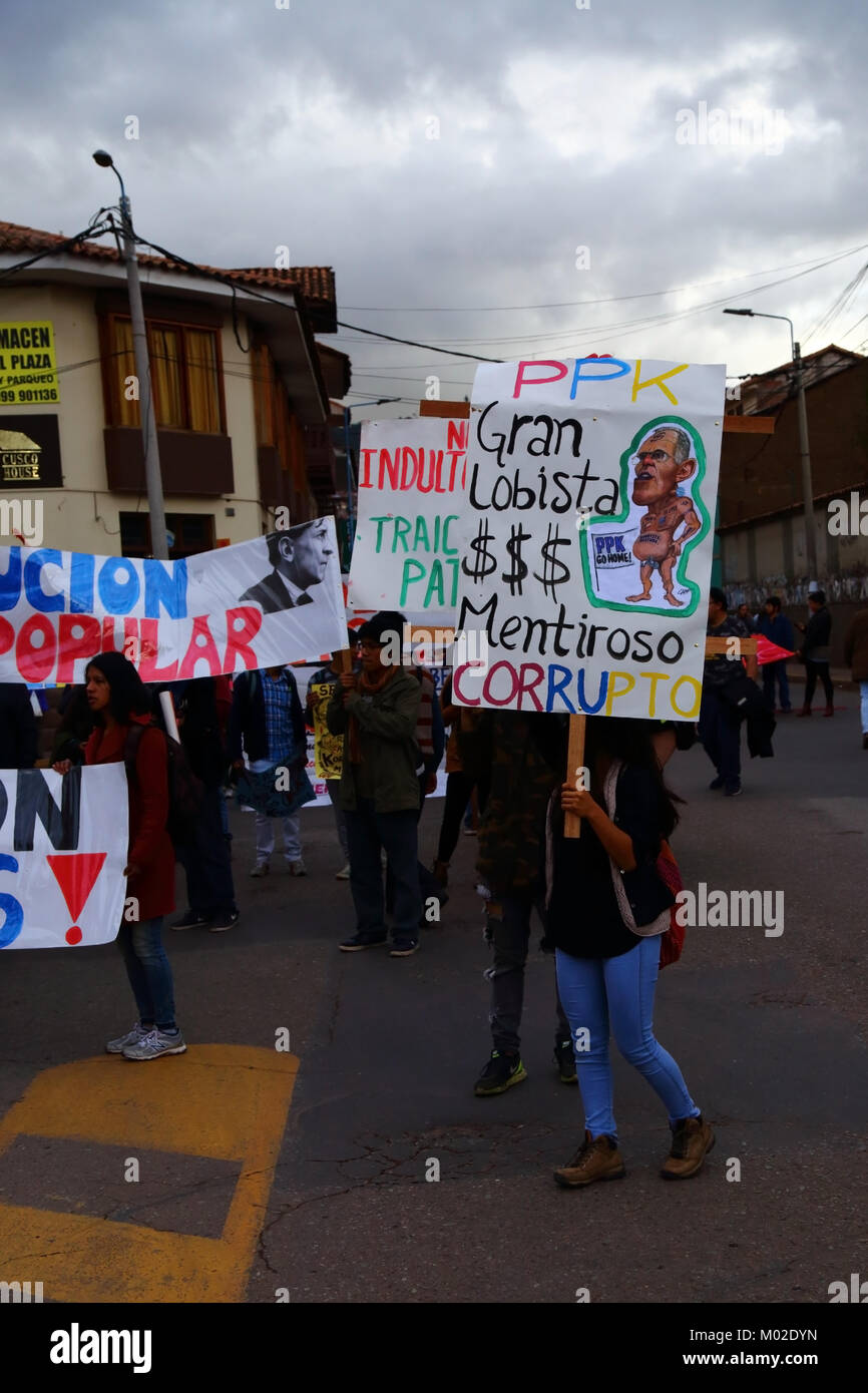 A protester carries a placard accusing Peruvian President Kuczynski of corruption during a protest march, Cusco, Peru Stock Photo