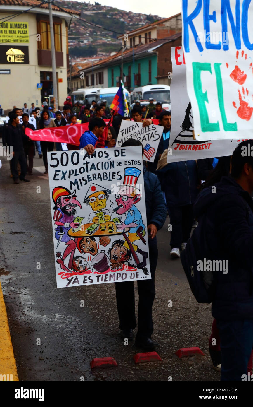 A protester carries a placard protesting against political corruption and foreign exploitation during a protest march, Cusco, Peru Stock Photo
