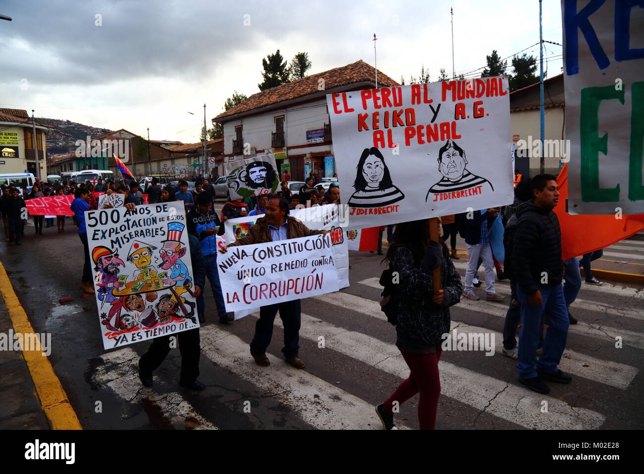 Protesters carry placards protesting against political corruption and foreign exploitation during a protest march, Cusco, Peru Stock Photo