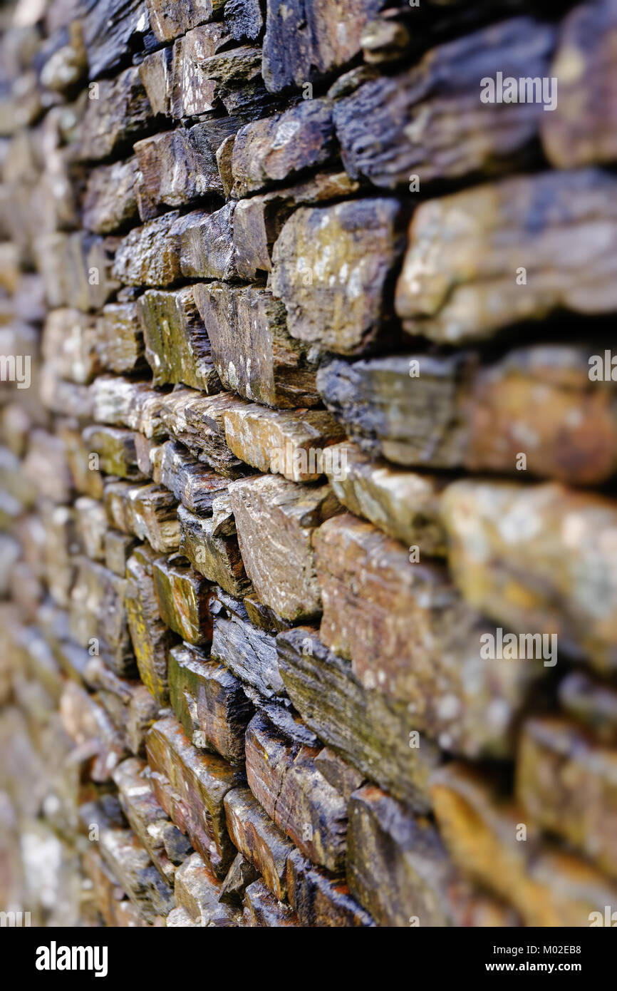 Layers of natural stone make up a  'Dry Stone Wall', a tradional method of construction using interlocking bricks held together by pressure rather tha Stock Photo