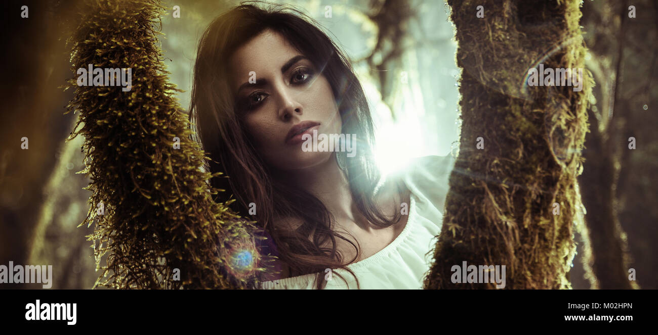 Portrait of a beautiful woman posing among trees Stock Photo - Alamy