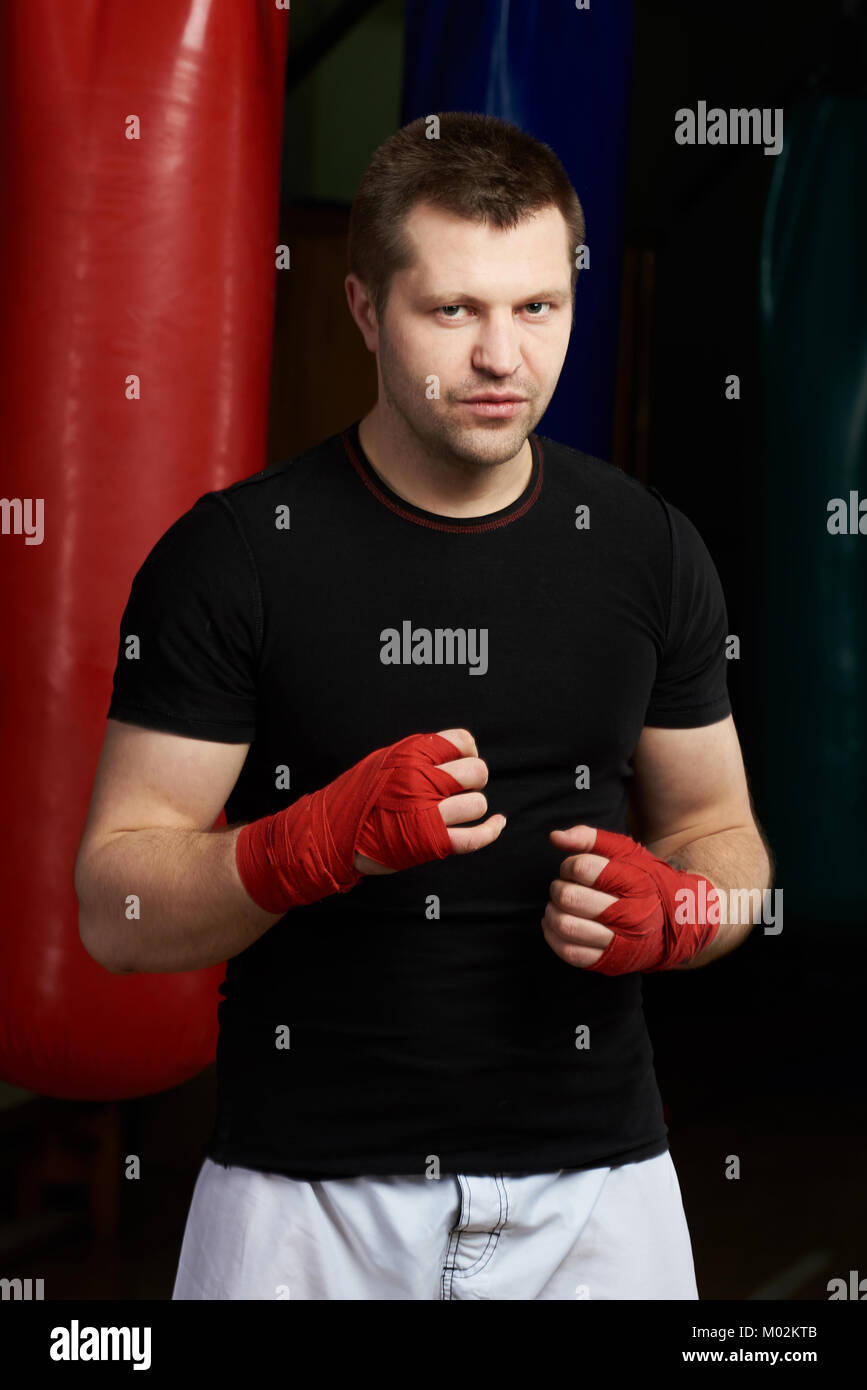 One boxing man in bandage holding hand up on gym background Stock Photo Alamy
