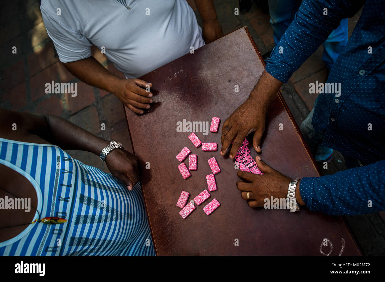 Colombian men play dominoes on the street in Cartagena, Colombia. Stock Photo