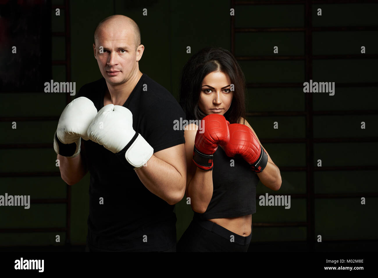 Boxing lessons concept. Young woman and man hold hands up in boxing gloves Stock Photo Alamy