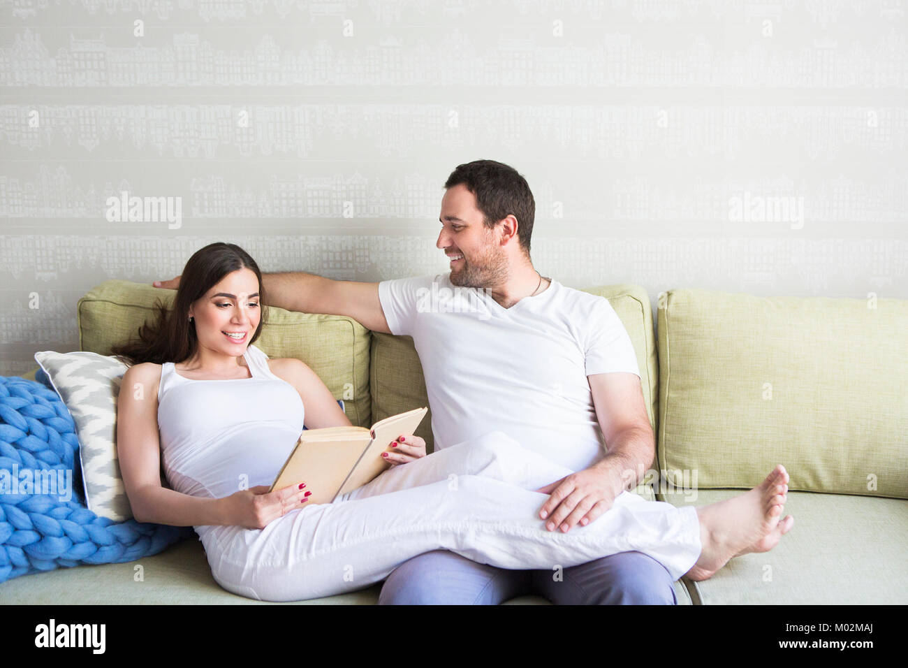 Pregnant woman and young man together indoors Stock Photo - Alamy