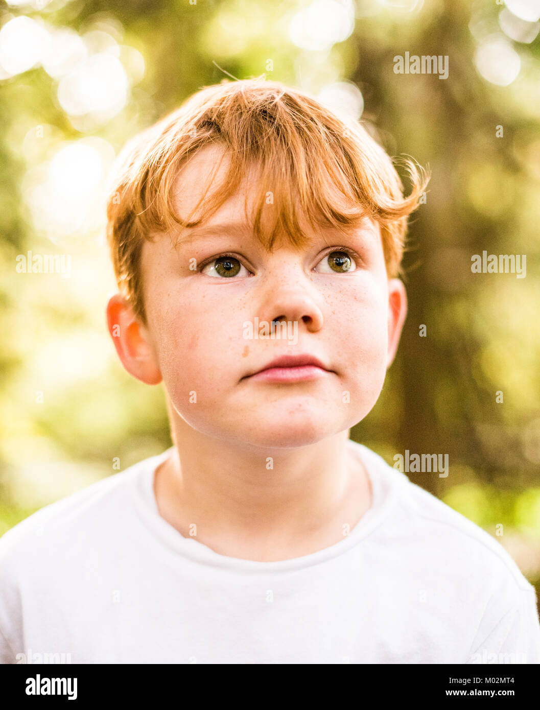 A youg red haired boy looking away from camera Stock Photo