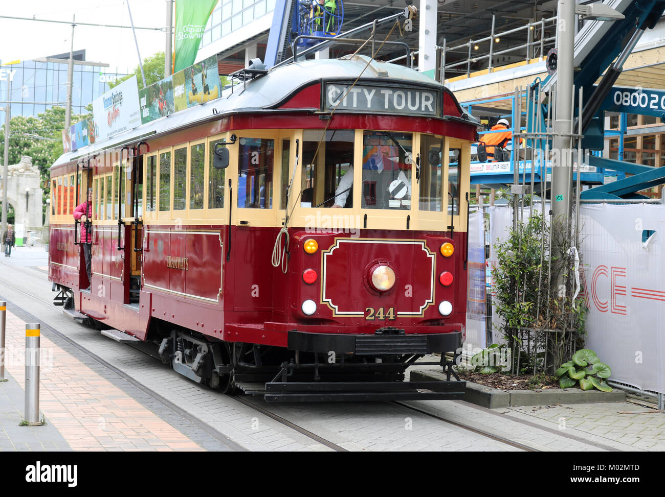 Historic vintage Christchurch tram number 244 on a city tour passing along Cashel Street in Christchurch, Canterbury, South Island, New Zealand. Stock Photo