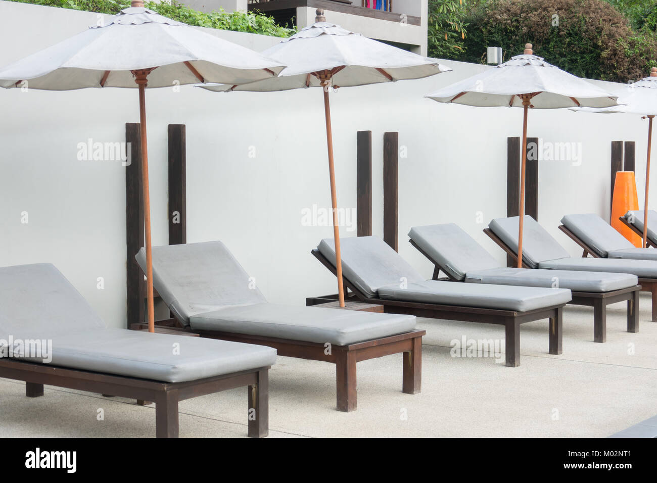 Beach chairs near swimming pool Stock Photo Alamy